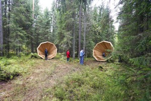 People gather near the wooden megaphones in the forest near Pahni village