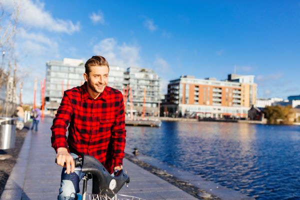 Estudiante joven manejando bicicleta en Dublin, Irlanda